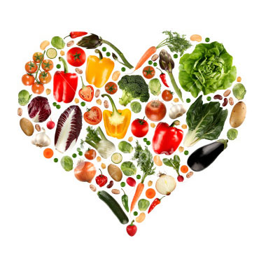 Photo of healthy fruits and vegetables arranged in a heart shape